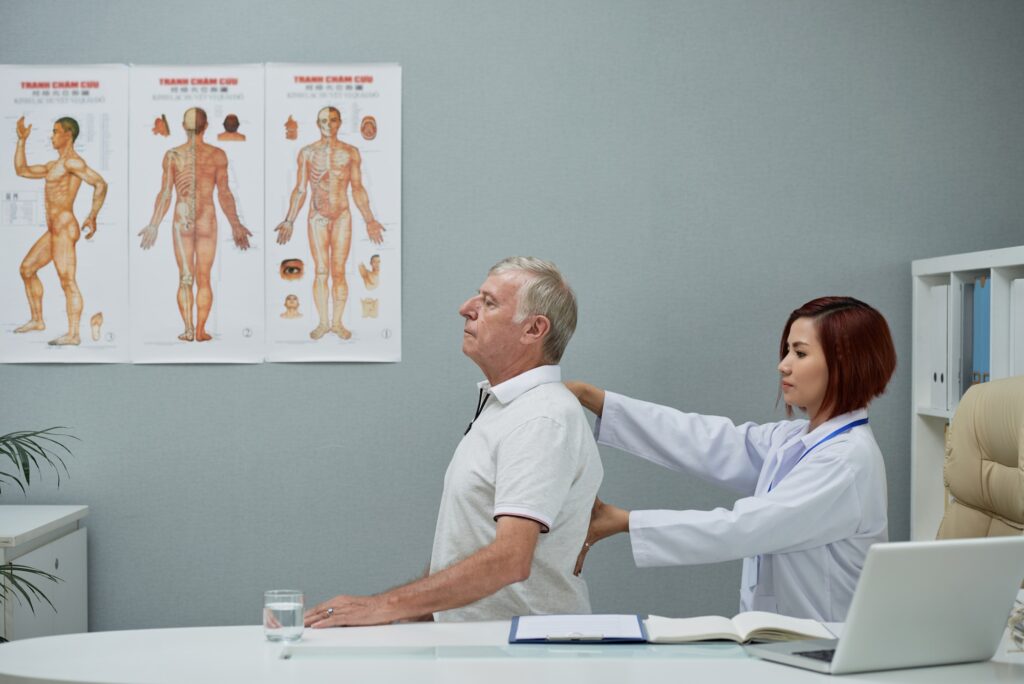 Chiropractor checking spine